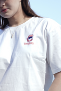 Person wearing a white t-shirt with a small Bagua logo and text against a clear blue sky.