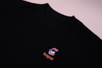 Black t-shirt with 'bagua' logo on a light pink background